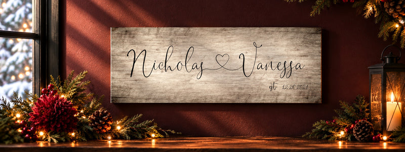 Christmas greenery and candlelight around a personalized wall plaque