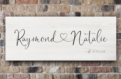 custom made established date signs with names connected by heart, shown in "white-wash"