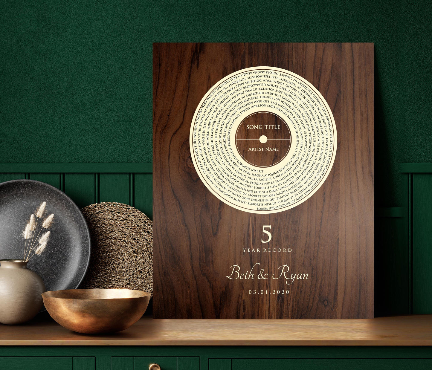 This is a photo of a 5th wedding anniversary, Our 5 Year Record wall plaque is a wood plaque - The record design pops in a natural birch tone set against a deep brown stained and polished birch - featuring song lyrics of choice in a vinyl record motif, accented with the couple's names with a heart symbol between then and the couples wedding date