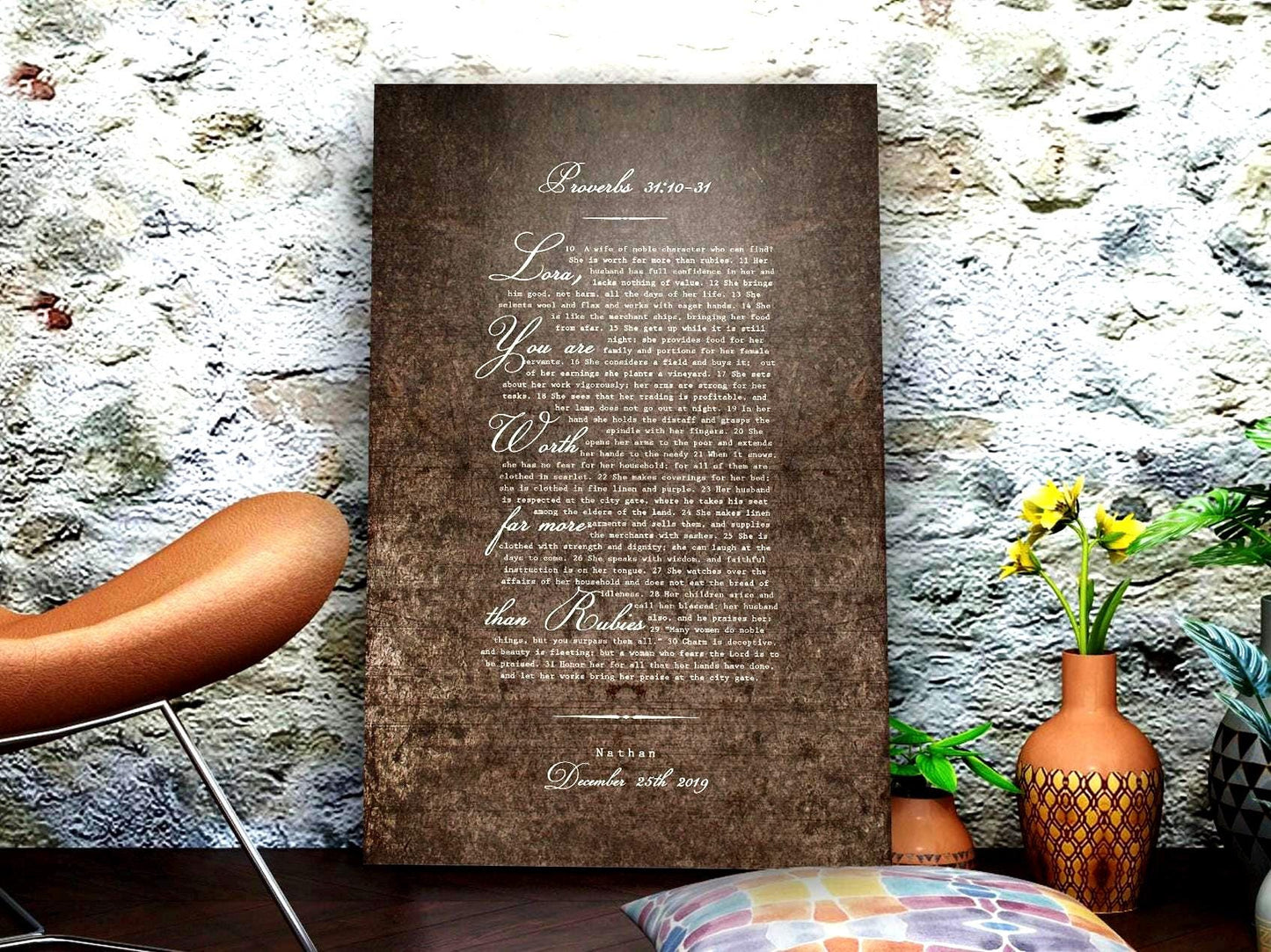 May include: A burnished metal sign with a white inscription of a Bible verse from Proverbs 31:10-31. The text reads "Lora, you are worth far more than rubies." The date "December 25th, 2019" is printed at the bottom.
