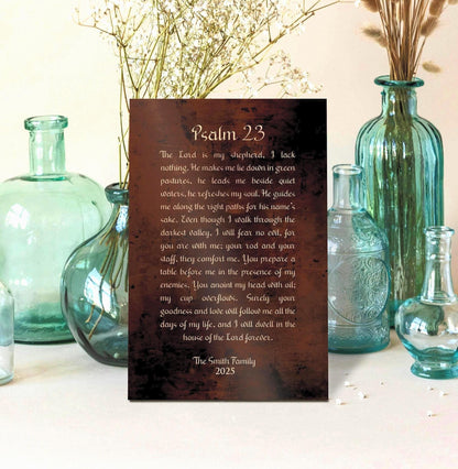 Personalized Psalm 23 Burnished Bronze Metal Plaque is center frame, surrounded by decorative glass-blown vessels and vases. The words of Psalm 23 are inscribed in old world script and "The Smith Family" and their established date is included beneath the Scripture inscription.  Photo courtesy of Honeycomb Proverbs