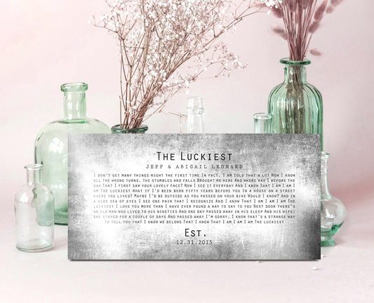 A 10th Anniversary Song Plaque is leaning against a glass-blown vase. Crafted on distressed tin, this rustic metal sign is inscribed with song lyrics, names and an established date.

Photo courtesy of Honeycomb Proverbs