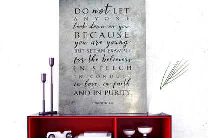 Metal Distressed Christian Wall Art with a black inspirational quote: "DO not LET ANYONE look down on you BECAUSE you are young BUT SET AN EXAMPLE for the believers IN SPEECH IN CONDUCT in love, in faith AND IN PURITY." The quote is attributed to 1 Timothy 4:12.

Photo courtesy of Honeycomb Proverbs
