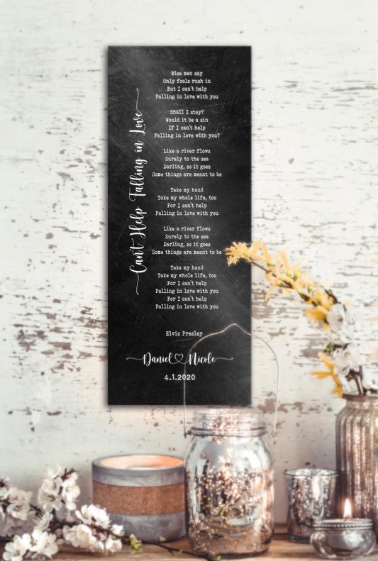Song lyric metal sign in a black distressed iron alloy with the song cant help falling in love