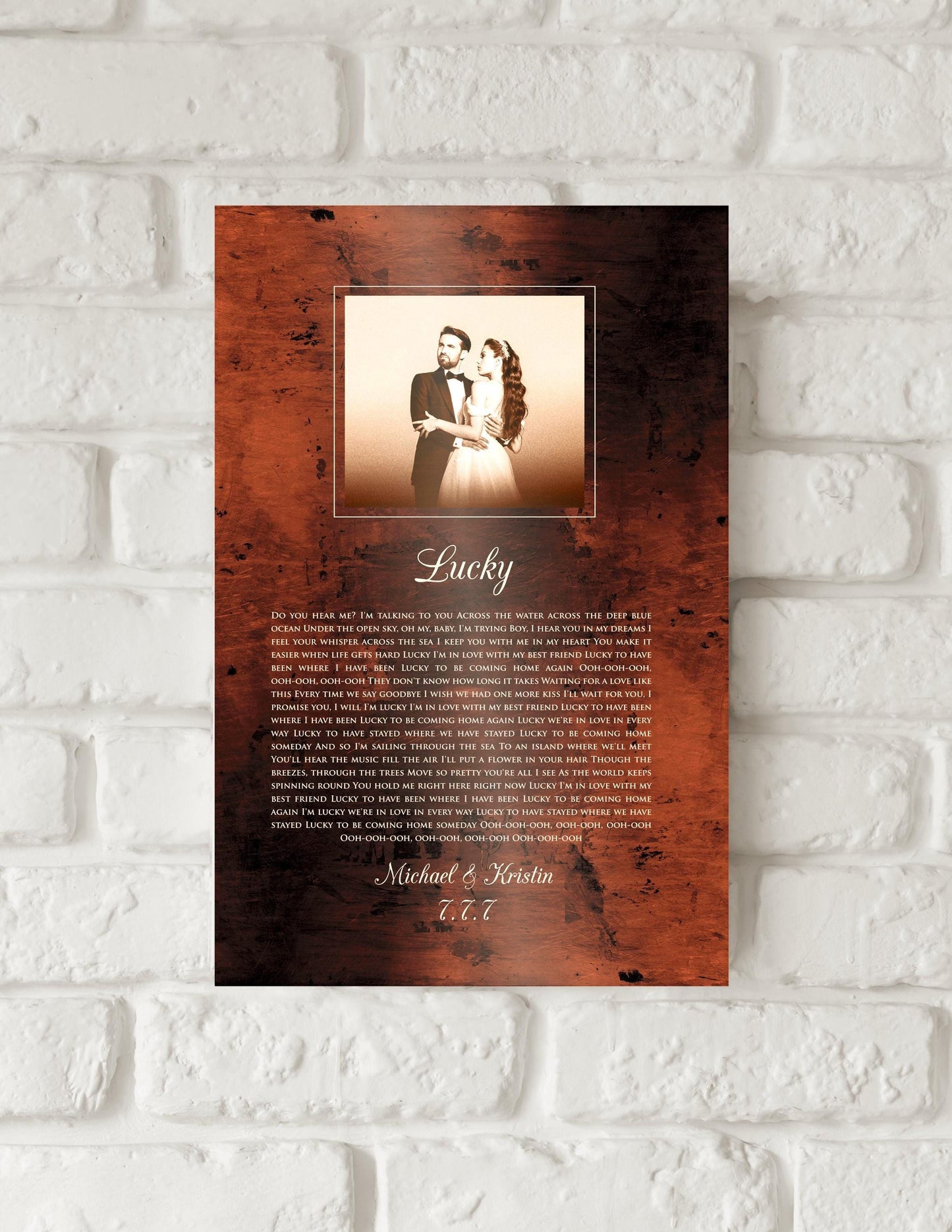 Bronze anniversary song plaque with photo of bride and groom framed at the top of plaque and song lyrics to Lucky beneath, followed by their names and wedding date.