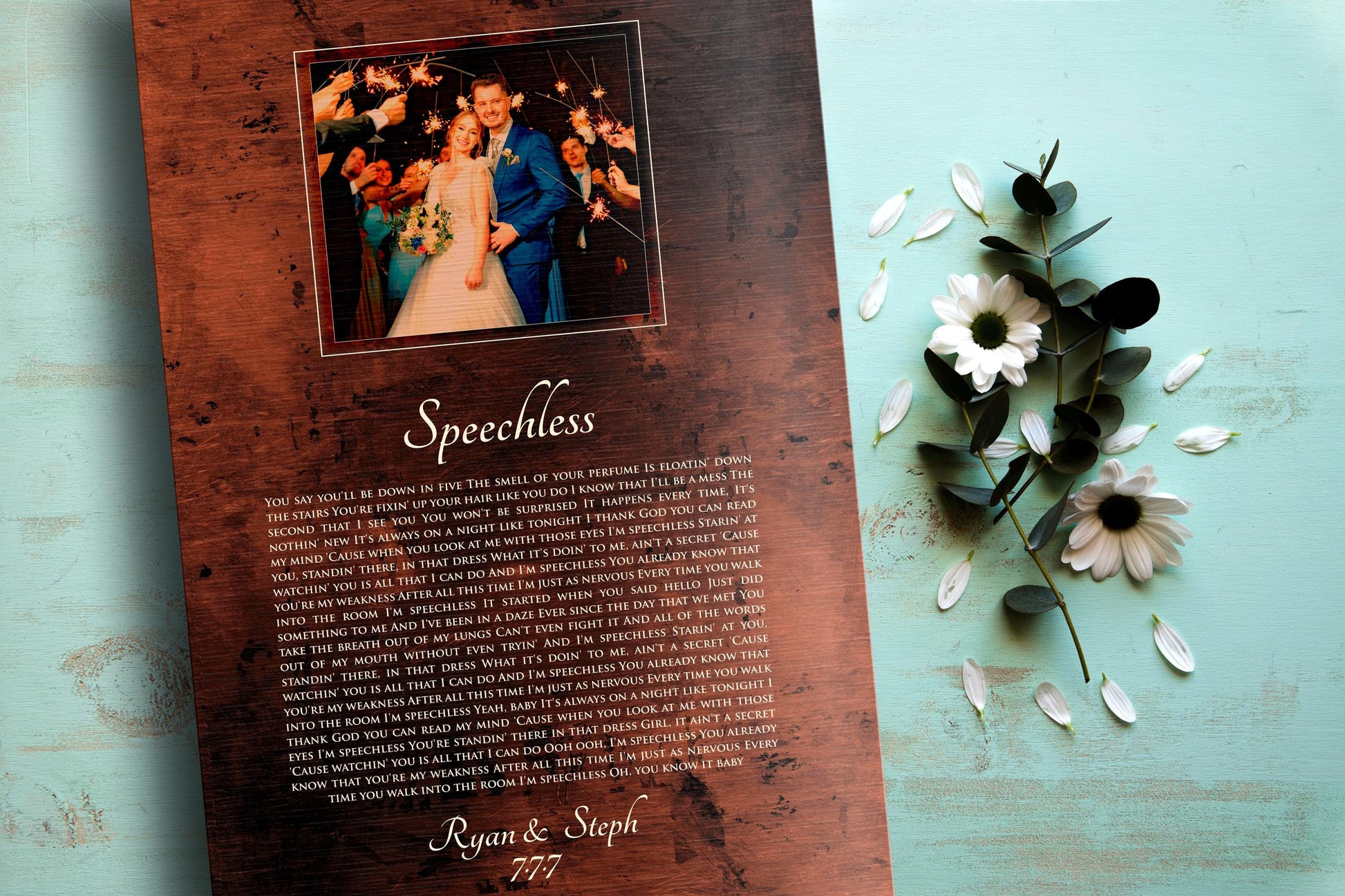 Bronze anniversary song plaque with photo of bride and groom framed at the top of plaque and song lyrics to Speechless beneath, followed by their names and wedding date.
