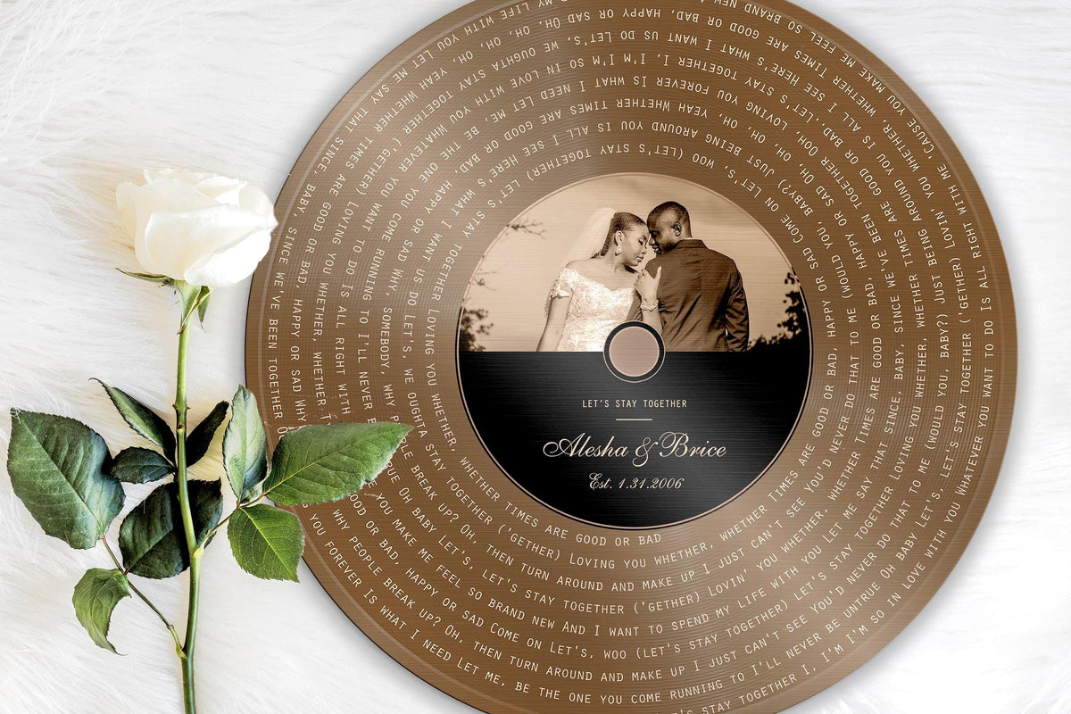 Bronze round song lyrics record with couple photo label and spiral lyrics, styled with a white rose
