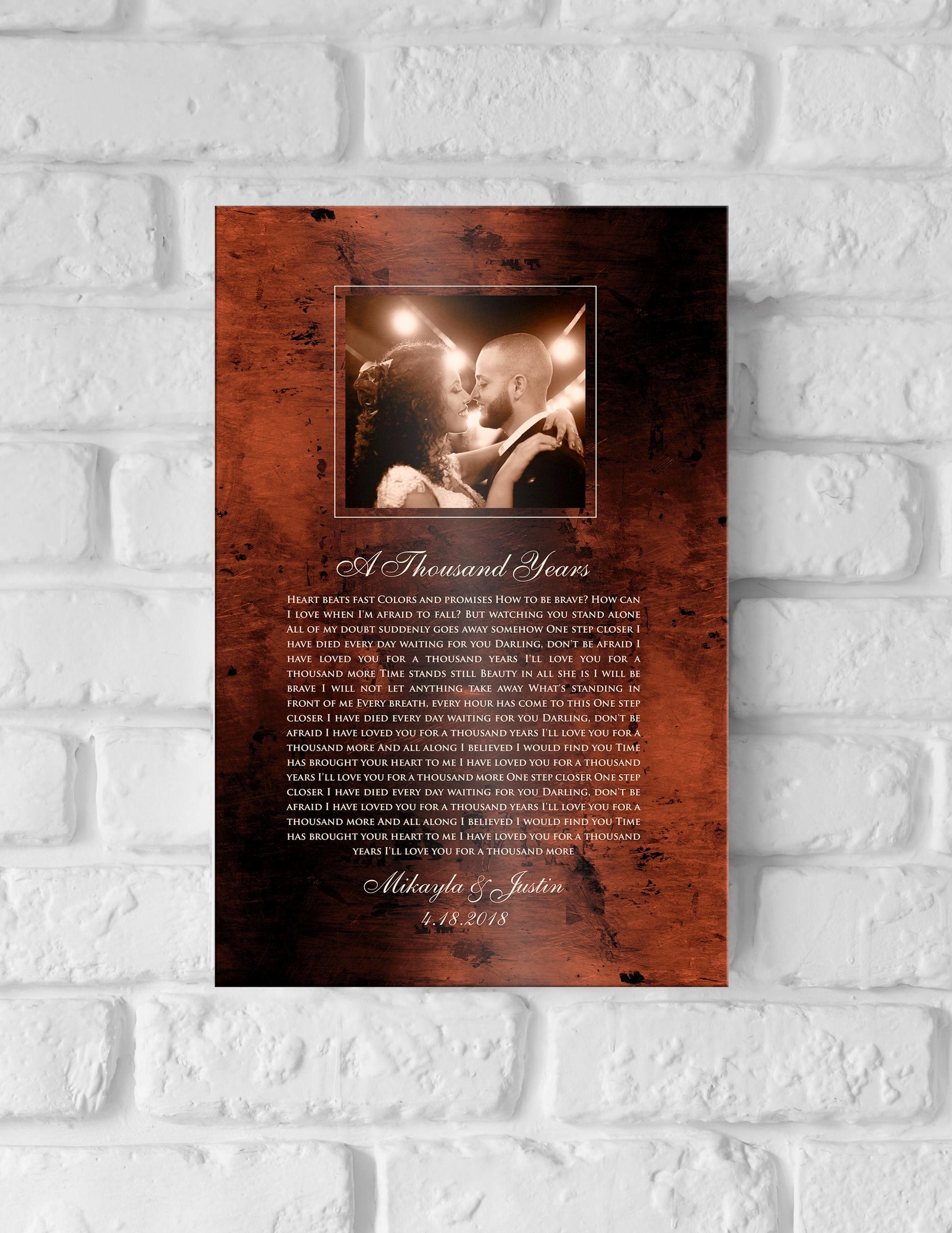 Bronze anniversary song plaque with photo of bride and groom framed at the top of plaque and song lyrics to A Thousand Years beneath, followed by their names and wedding date.