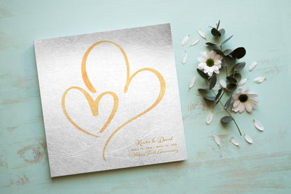 Distressed tin anniversary plaque with brass-toned nested hearts and first names, a 10th anniversary tin gift