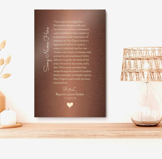 custom bronze song, lyric sign with heart names and date at the bottom in a vertical format on brushed bronze metal.