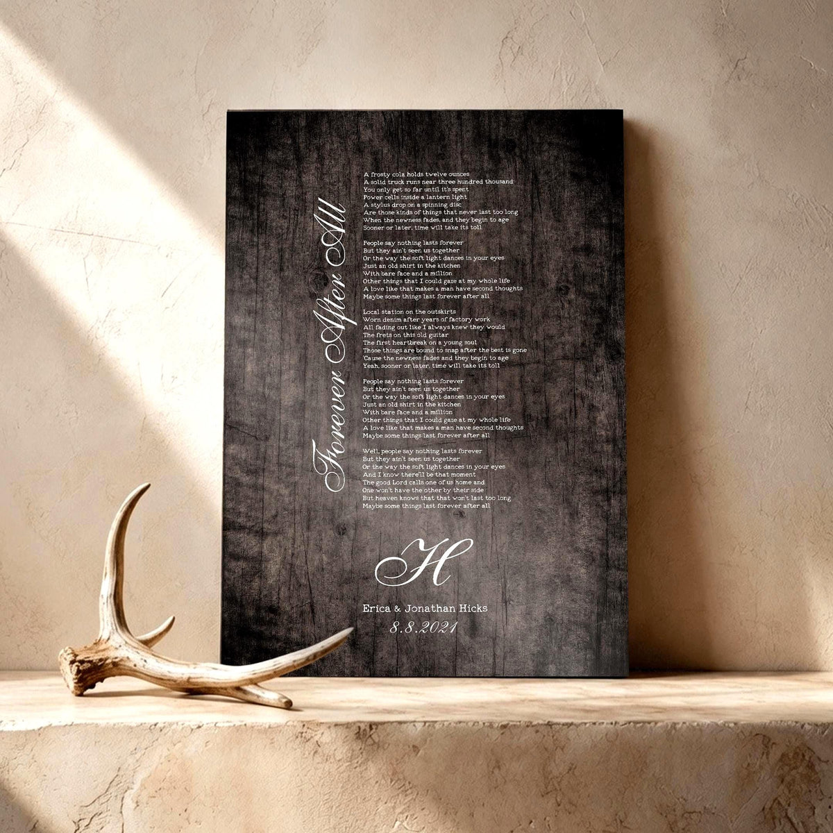 Wooden Anniversary Gift Decor custom designed for him or her with song lyrics of choice, names and date. Featured on a rustic barn grey finish leaning on a shelf with a lone antler sharing the frame in the lower left third of the image.