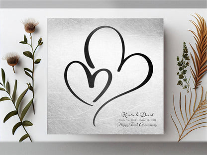 Distressed tin hearts plaque, a large black heart around a smaller one, first names and a tenth anniversary wish